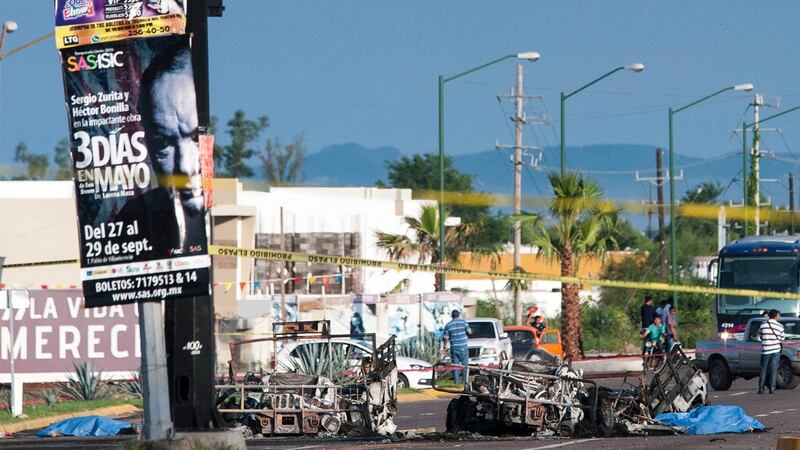 Police investigators examine the site where a military convoy was ambushed with grenades and high-powered guns, killing five soldiers in the city of Culiacan, Mexico on Friday. Photograph: Hector Parra/AP