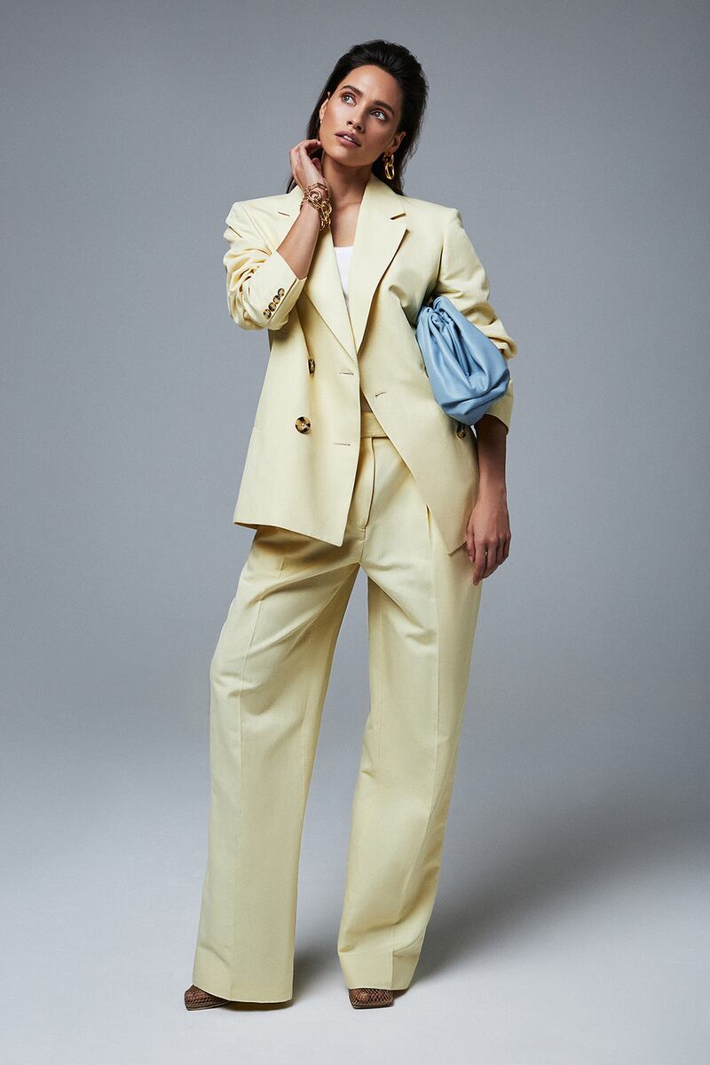 How to do tailored: Lemon linen blazer €300 Remain, white ribbed vest €75 Dries Van Noten, lemon linen trousers €160 Remain, blue leather clutch €2,100 Bottega Veneta, chain link bracelet €95 Kenneth Jay Lane, chain link earrings €100 Kenneth Jay Lane, nude mesh shoes €690 Bottega Veneta