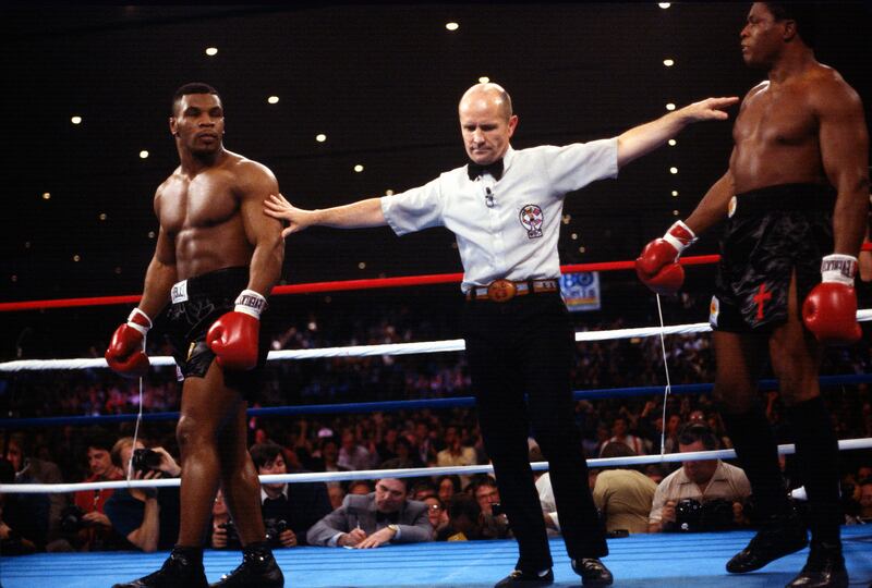 Mike Tyson (left) KO'd Trevor Berbick in the second round of their WBC heavyweight title fight in 1986 to become world champion aged 20. Photograph: Focus on Sport/Getty Images