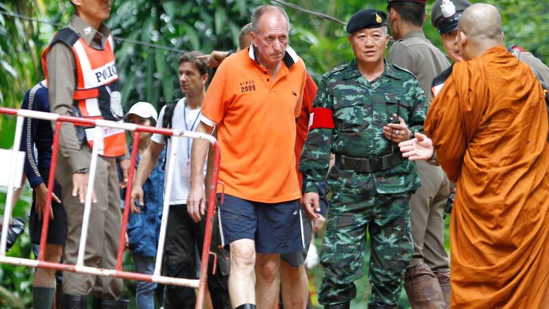 British cave diver Vern Unsworth (C) walks next to a Thai soldier and policemen during the   cave rescue operations. Photograph: Pongmanat Tasiri/EPA