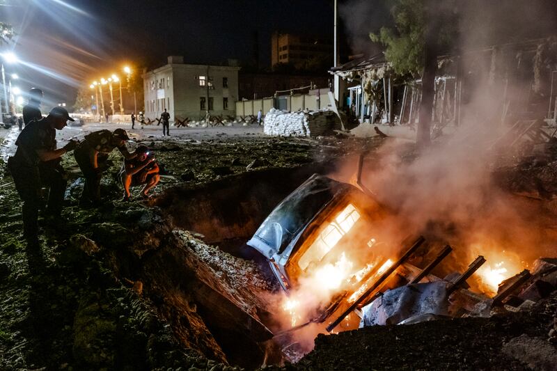 The wreckage of a car burns in a crater after a Russian missile strike in Dnipro, in central Ukraine. Photograph: Daniel Berehulak/The New York Times