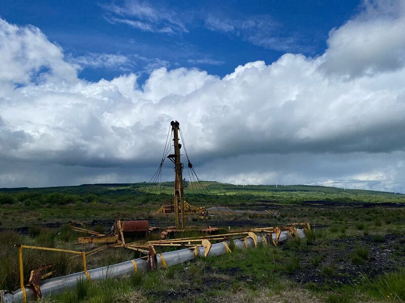 Abandoned industrial bog cutting machines, and windmills in the distance. Photograph: Deirdre Falvey