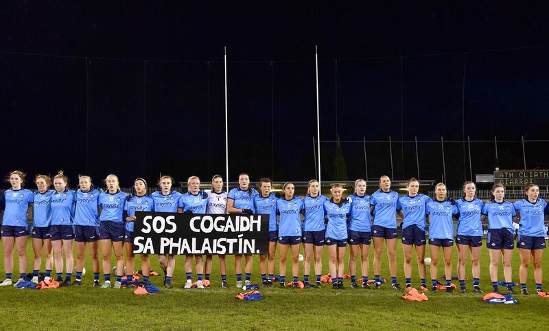 Dublin players hold a banner showing solidarity with Palestine before the National Football League game against Kerry at Parnell Park. Photograph: Sam Barnes/Sportsfile 