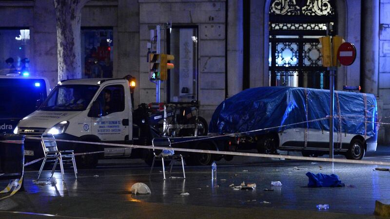 The van which was driven into a crowd, killing at least 13 people and injuring around 100 others in Barcelona,  is towed away by police  on Friday. Photograph: AFP