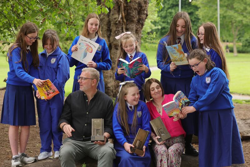 KPMG Children’s Books Ireland Awards 2024: Authors Brian Conaghan and Serena Molloy with Allanah O’Donoghue, fifth class student, photographed with her fellow book club members from Patrick's Girls National School, Limerick. Photograph: Alan Betson 