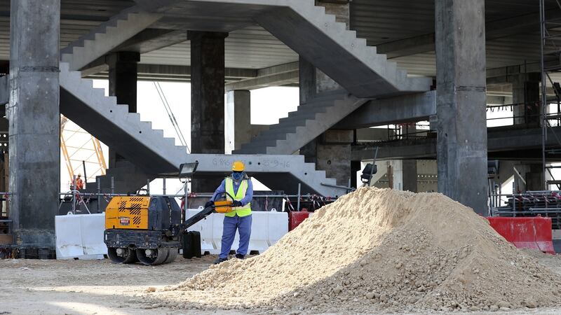 Workers are seen during a tour at the construction site of the Al Bayt Stadium. Photo: Lars Baron/Bongarts/Getty Images