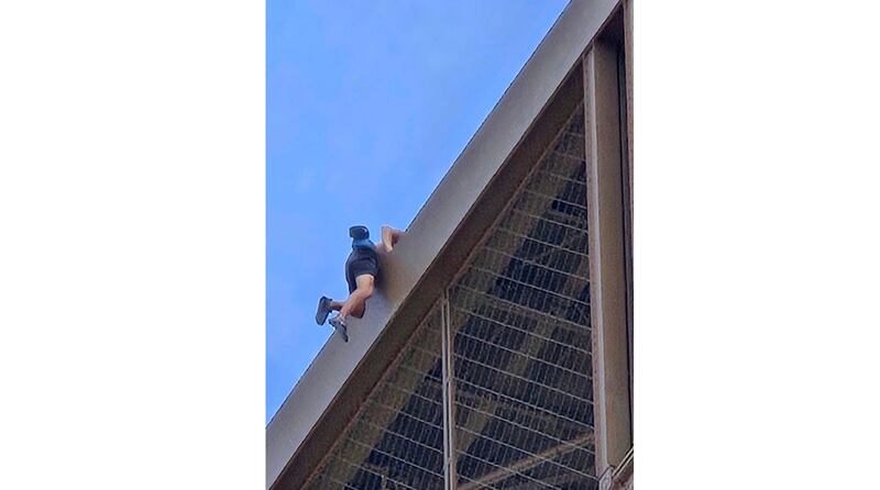 A man climbs the Eiffel Tower on Sunday. Photograph: Nickey Worlock via AP