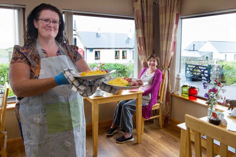 Karen Mannion, owner of Ocean Heights B&B, serving Marese McDonagh breakfast. Photograph: Brian Farrell