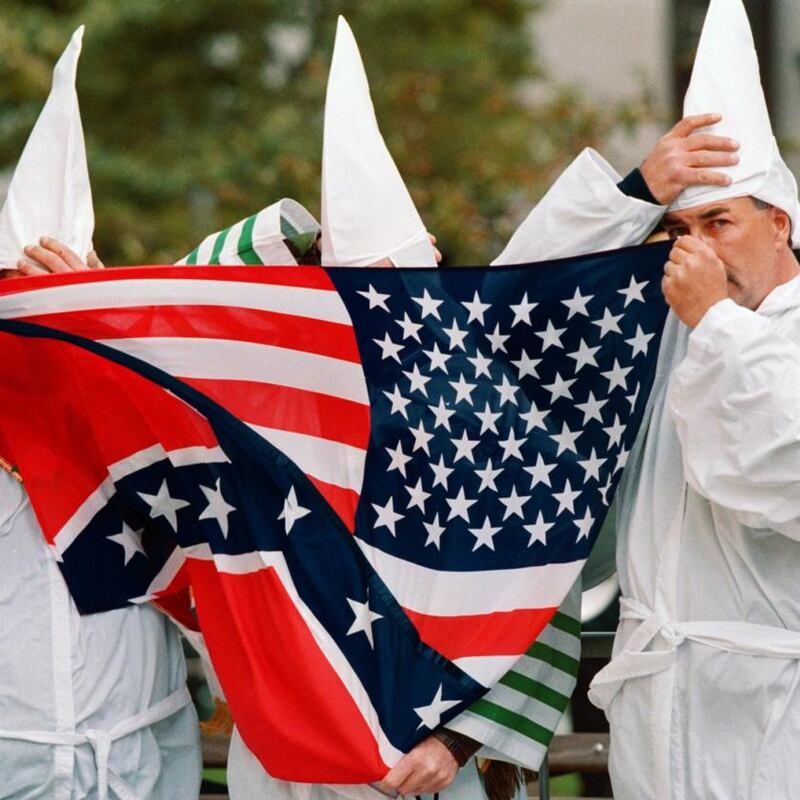 Ku Klux Klan members behind a Confederate-US flag in in 1999. Photograph: Doug Kanter/AFP via Getty