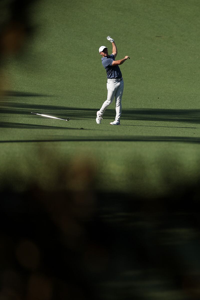 McIlroy releases his club after his second shot on the 10th hole. He completed back-to-back birdies to move to -14 and a four-shot lead. Photograph: Richard Heathcote/Getty Images