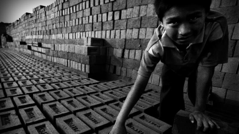 Juan Huachaca flips the bricks to facilitate its drying at the brick factory in  Huachipa