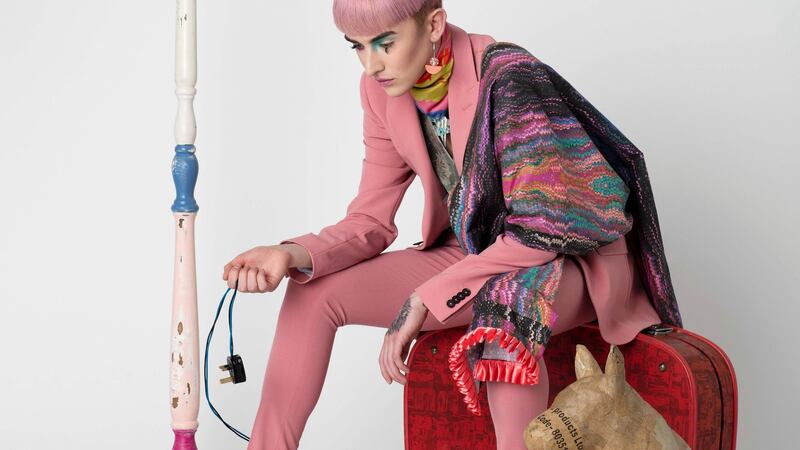 Pink trousers, €70, and jacket, €150, Topman,  Cork; knit waistcoat, €150, Salinger’s Cork, salingers.ie; pink marble daydream eco cotton throw, €120, Aisling Duffy Designs, aislingduffy.co.uk; silk scarf, €130, Ciara Silke, ciarasilke.com; purple earrings, €19, Sandia Dublin, sandiadublin.com; chain €55, Rothlu.ie; props: The Village Hall, Cork, Tom Campbell dog sculpture.