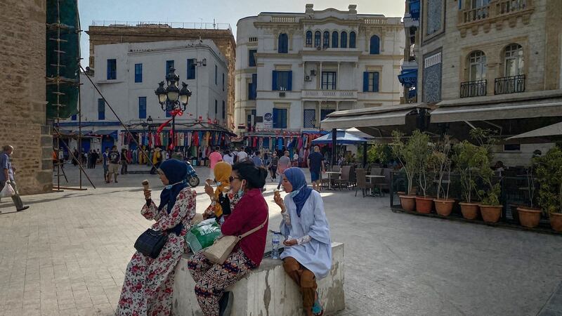 People eat ice cream in a square near the old markets in Tunis. Photograph: Sima Diab/The New York Times