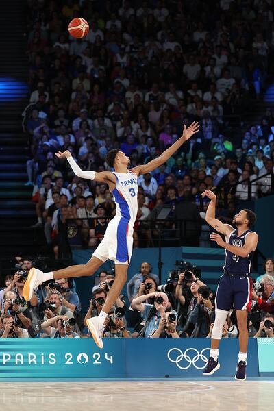 Stephen Curry of the USA shoots over France's Victor Wembanyama during the men's gold-medal match at the Olympics. Photograph: Ezra Shaw/Getty Images