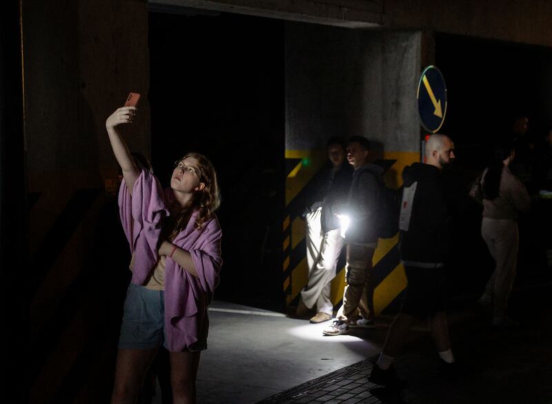 A young girl takes a selfie as locals hide in a shelter during an air-raid alarm, near a site of a drone strike on a residential building in Kyiv. Photograph: Sergey Dolzhenko/European Pressphoto Agency