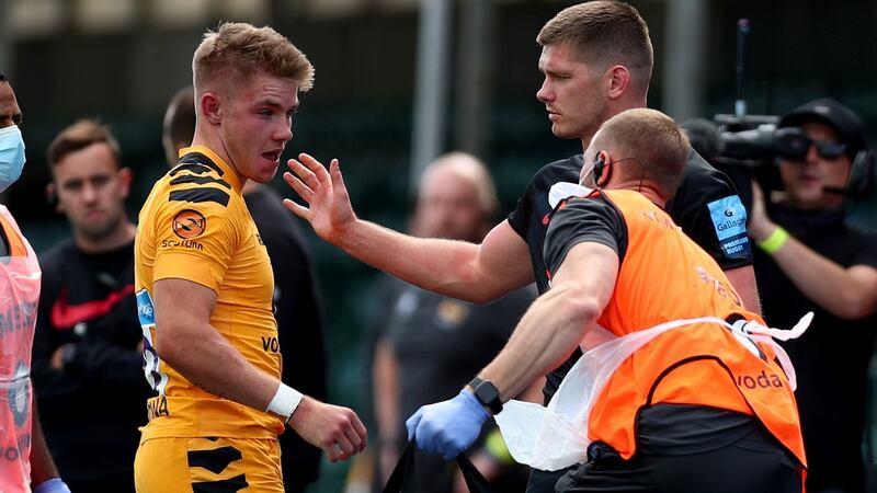 Owen Farrell of Saracens apologises to Charlie Atkinson of Wasps after being sent off for a previous tackle on him. Photograph: Clive Rose/Getty Images