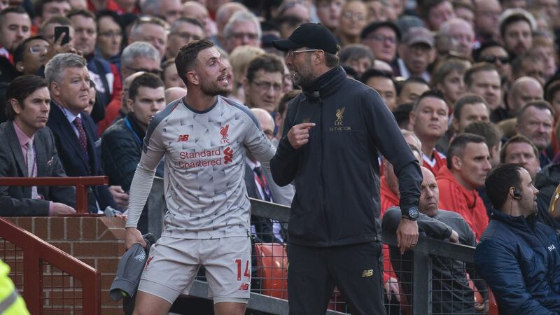 Jordan Henderson  reacts with Liverpool manager Jürgen Klopp after his substitution during the Premier League game against Manchester United at Old Trafford. Photograph:   Peter Powell/EPA