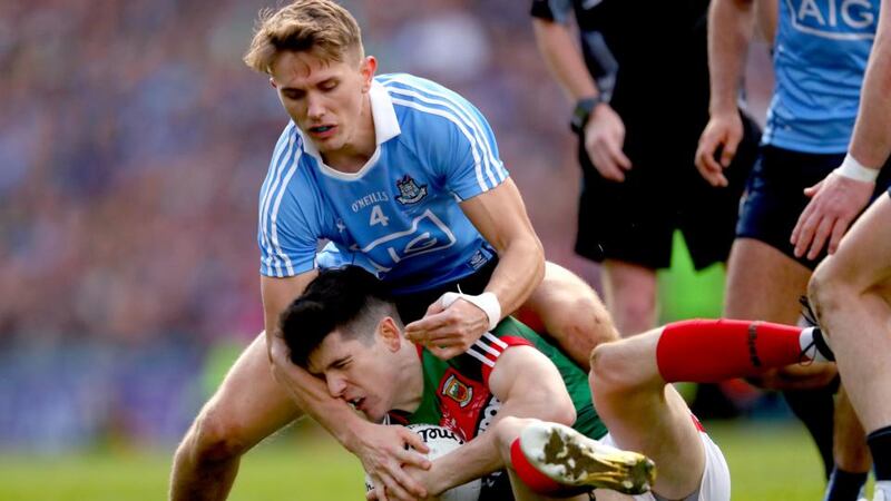 Dublin’s Michael Fitzsimons in action against Conor Loftus of Mayo during the All-Ireland final.  Photograph: James Crombie/Inpho