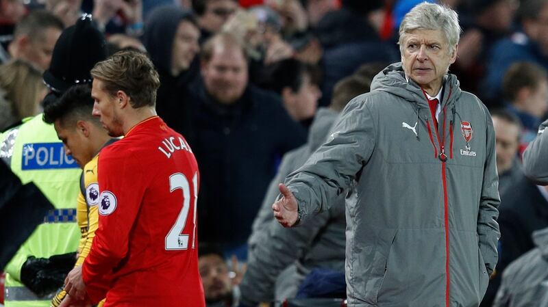 Alexis Sanchez walks past Arsene Wenger after the defeat to Liverpool. Photo: Phil Noble/Reuters