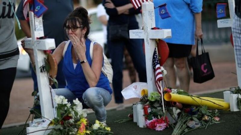 A woman cries at a makeshift memorial for victims of a mass shooting. Photograph: John Locher/AP