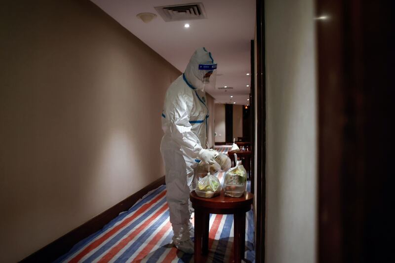 A hotel employee in a protective suit delivers food at a quarantine hotel for guests in Xiamen, Fujian province, China on December 22nd. Photograph: Mark R Cristino/EPA-EFE