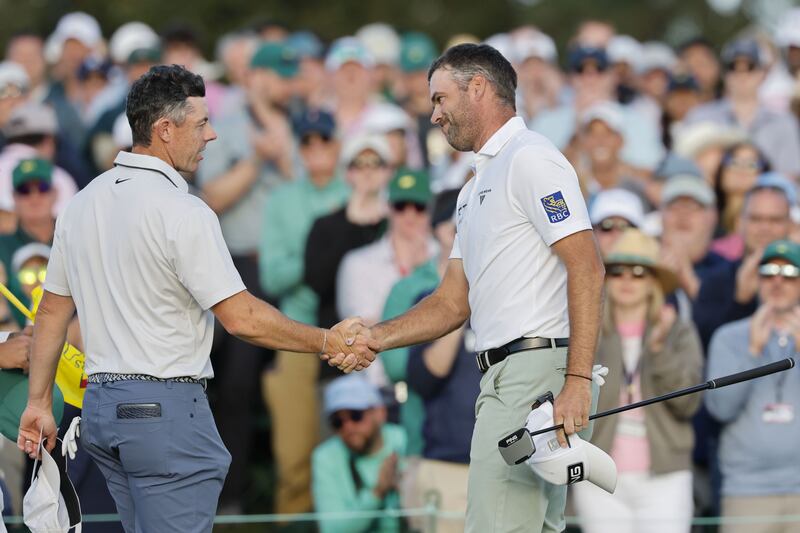 Rory McIlroy shakes hands with pairing partner Corey Conners on the 18th green at the end of their third round. The Irishman's 66 brought him to 12 under and gave him a two-shot overall lead. Photograph: CJ Gunther/ EPA