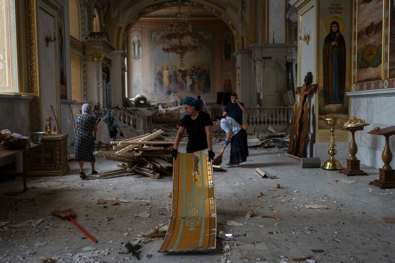 People clean up inside the Odesa Transfiguration Cathedral (Jae C. Hong/AP)