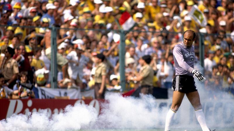 Brazil goalkeeper Waldir Peres walks away from his goal as smoke billows from a flare. Photograph: Mark Leech/Getty Images