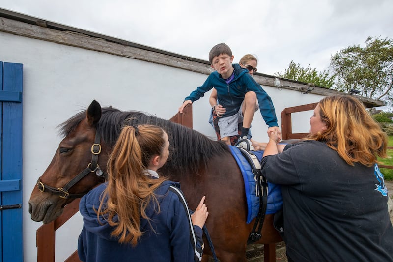 Georgia Lillis and Aoife Weldon with Rogan Spencer (15), his mother Carrieanne and Rosie the pony at the Royal Stables. Photograph: Tom Honan