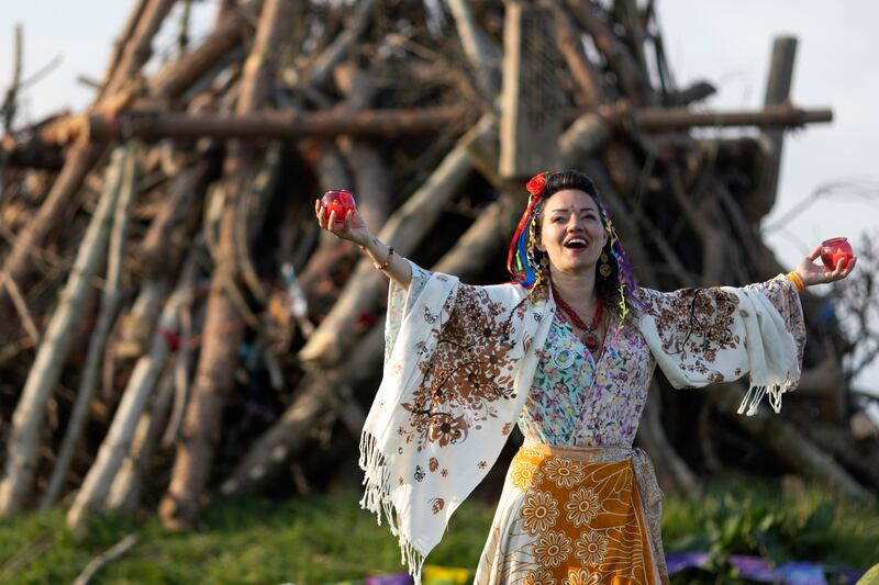 Daniela Barcellos, from Dublin, dances around the unlit bonfire pile