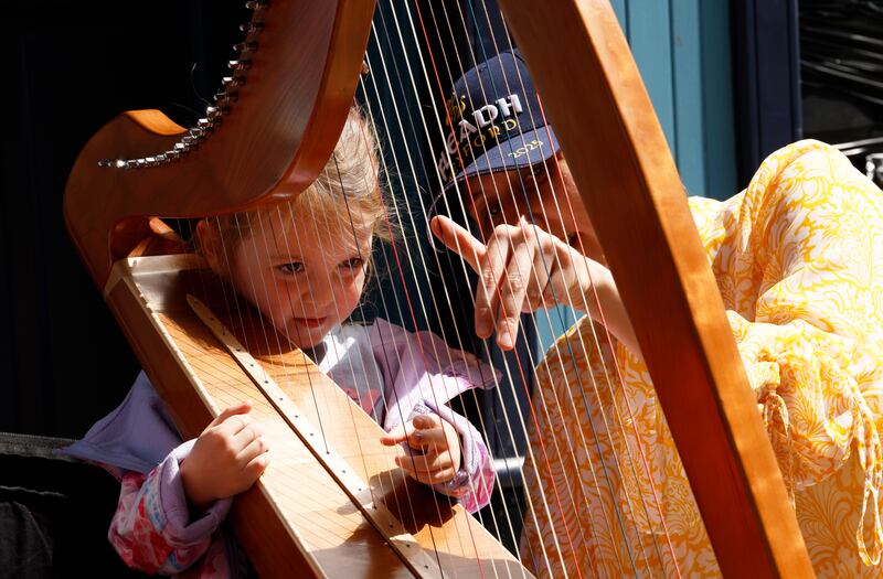 Ellamay Fribbs from Fethard, Co Tipperary, listens attentively during a harp-playing demonstration. Photograph: Nick Bradshaw