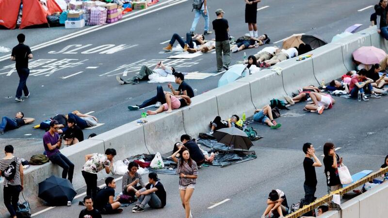 Pro-democracy demonstrators sleeping early this morning on a bridge outside Hong Kong’s government offices on the fifth day of the mass civil disobedience campaign Occupy Hong Kong. Photograph: Dennis M Sabangan/EPA