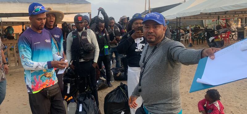 A queue of migrants being directed to board a ferry in Necoclí. Photograph: Peter Murtagh