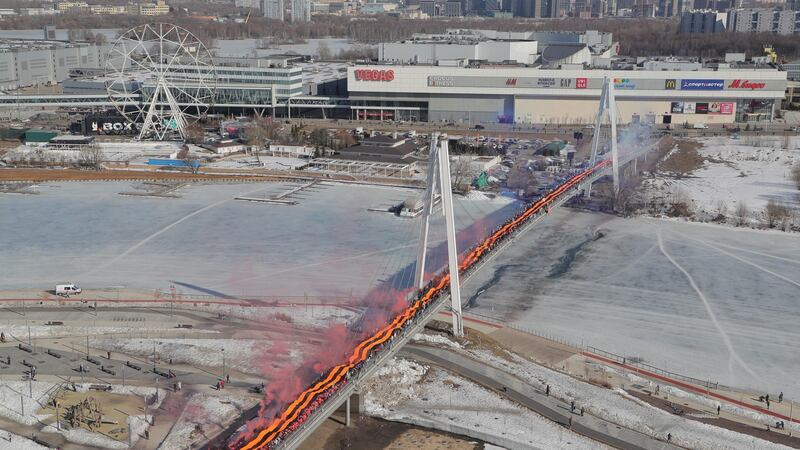 People wave a 423m-long St George ribbon, a Russian military symbol, during a rally in support of Russian armed forces. Photograph: EPA