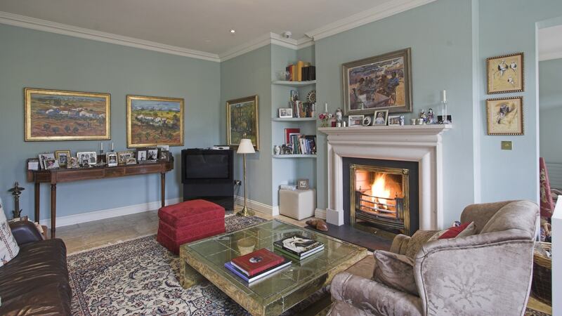 Reception rooms at the front of the house flow into one another: the front porch opens into a reception hall which opens through an arch into the drawingroom.