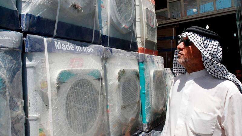 A customer looks at an Iranian-made washing machine at a store in the Iraqi capital, Baghdad.  Caught in the crossfire between Tehran and Washington, Iraq could suffer the heaviest collateral damage from the renewed US economic sanctions which took effect against Iran on Wednesday. Photograph: Getty Images