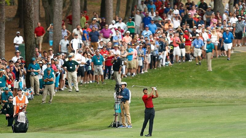 Woods plays his second shot on the 18th hole during the final round of the Valspar Championship. Photo: Michael Reaves/Getty Images