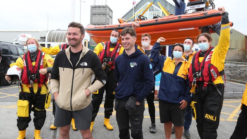 Patrick Oliver and his son Morgan, who rescued the two women off Inis Oirr island, with some of Patrick’s RNLI colleagues on their arrival back at the Galway RNLI Lifeboat Station at Galway Docks. Photograph: Joe O’Shaughnessy