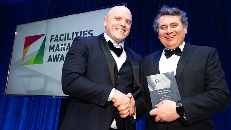 Stephen Mills, Head of Corporate, Aiken Insurances, presents the FM Team of the Year - Service Provider Award to Greg Wilson, Sensori FM.