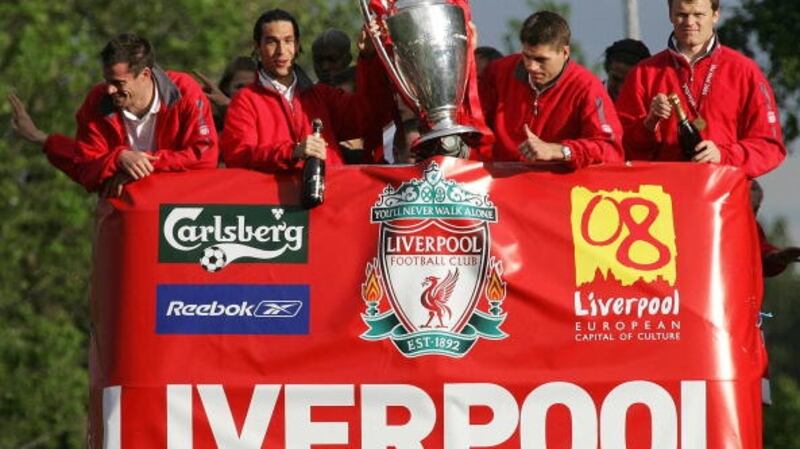 The 2005 Liverpool team show the Champions League trophy to the thousands of fans gathered to welcome them home. Photograph: Getty Images