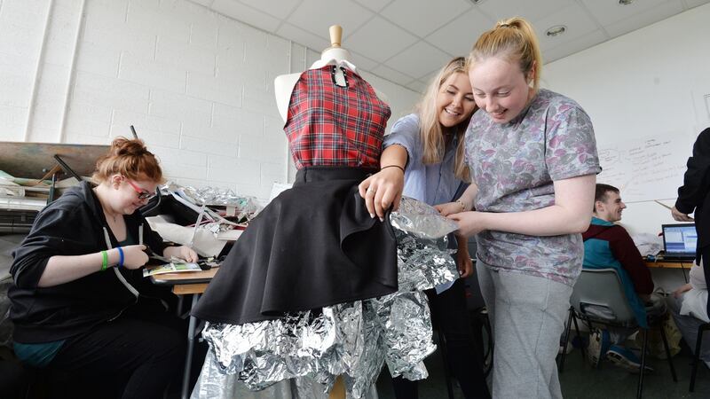 Creative Lab: Rebecca Kelly (left) and Chelsea Burke (right) work on their dress with artistic facilitator Sophia Vigne Welsh. Photograph: Alan Betson