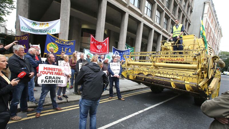 A  combine harvester is driven outside the  Department of Agriculture offices on Kildare St in Dublin. Photograph: Finbarr O’Rourke
