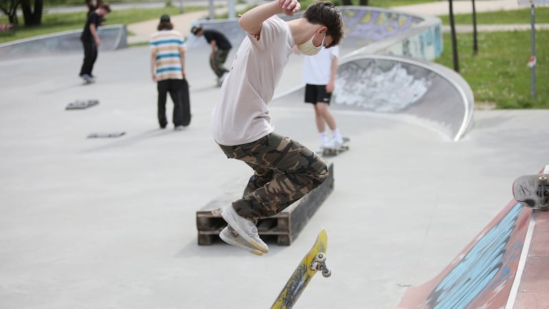 A skateboarder wearing a facemask uses a reopened skatepark in Warsaw, Poland. Photograph: Leszek Szymanski/EPA