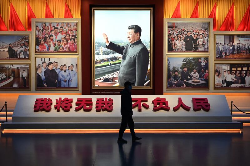 A man walks past a photograph of Chinese President Xi Jinping at the Museum of the Communist Party of China in Beijing. The party says that one-party rule is the perfect system for China. Photograph: Great Baker/AFP via Getty Images