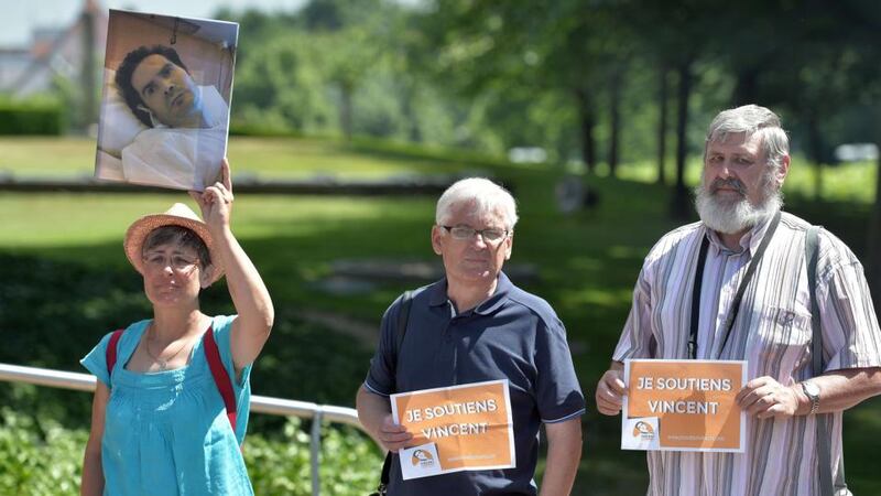 People hold placards and a picture of Vincent Lambert during the hearing  on his case at the European Court of Human Rights in  Strasbourg. Photograph: Patrick Hertzog/AFP/Getty Images