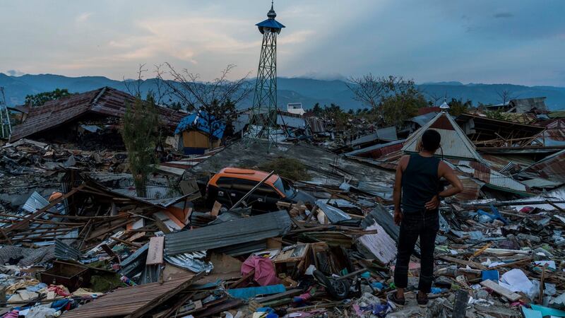 People salvage materials and belongings from the earthquake-damaged remains of Petobo neighborhood in Palu, Indonesia on October 4th Photograph: Adam Dean/The New York Times