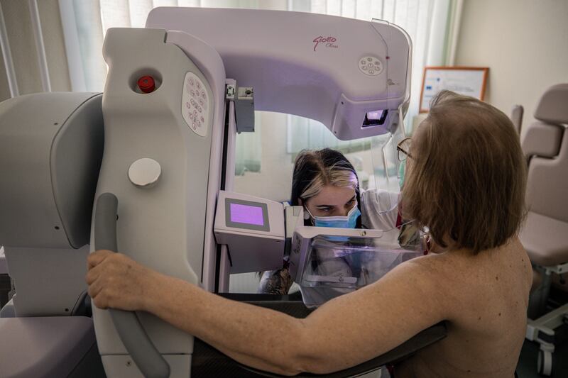A patient gets a mammogram at Bács-Kiskun County Hospital in Kecskemét, Hungary, Feb. 20, 2023. Hungary has become a major testing ground for AI software to spot cancer, as doctors debate whether the technology will replace them in medical jobs. (Akos Stiller/The New York Times)