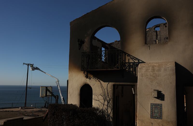 Utility crews repair electrical lines damaged by the Palisades fire on Sunday. Photograph:Justin Sullivan/Getty 