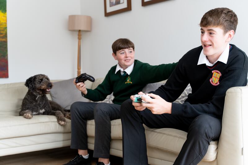 Frankie the dog watches brothers Luke and Patrick get their game-on, glitch-free