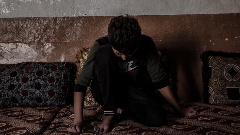 A Yezidi boy (13) in his house in Sinuni. “I feel lonely all the time. When I went to the hospital in Sinuni, I asked them to keep me there. I don’t want to be home.” Photograph: Emilienne Malfatto